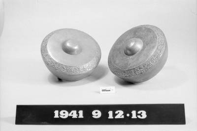 One of a set of 12 small ornamented brass gongs each with a central boss